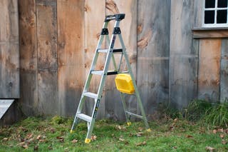 The Gorilla GLX-5B 5.5 ft. Aluminum Dual Platform Ladder next to a fence.