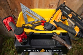 The Gorilla GLX-5B 5.5 ft. Aluminum Dual Platform Ladder tool tray, with tools in it.