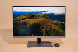 The BenQ PD2706U monitor showing a vineyard desktop background.