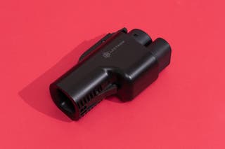 The Lectron Tesla Supercharger (NACS) to CCS 500A Vortex Plug Adapter on display in front of a red background.