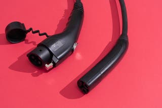 A close up of a Gizzel-E and emporía EV charger input with a red background.