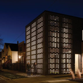 House with Woven Brick Screen Enclosing Home and Garden