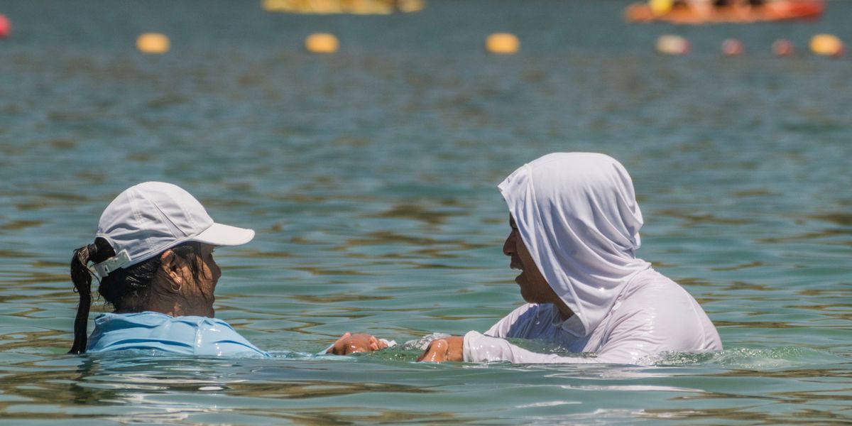 Adults wear light clothes as they cool off at Castaic Lake as temperatures rise, Monday, July 8, 2024, in Castaic, Calif.  (AP Photo/Damian Dovarganes)