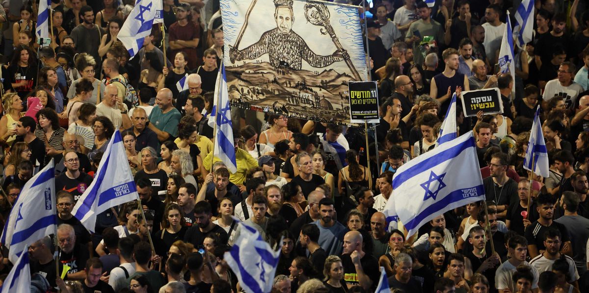 TOPSHOT - Protesters lift flags and placards during an anti-government rally calling for the release of Israelis held hostage by Palestinian militants in Gaza since October, in Tel Aviv on September 1, 2024. Families of Israeli hostages have called for a nationwide general strike starting September 1 night to force the government to reach a deal to secure the release of captives still held in Gaza. (Photo by Jack GUEZ / AFP)