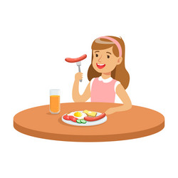 cute girl eating sausage while having breakfast vector image