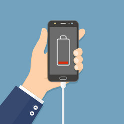 hand holding smartphone with charger connected vector image