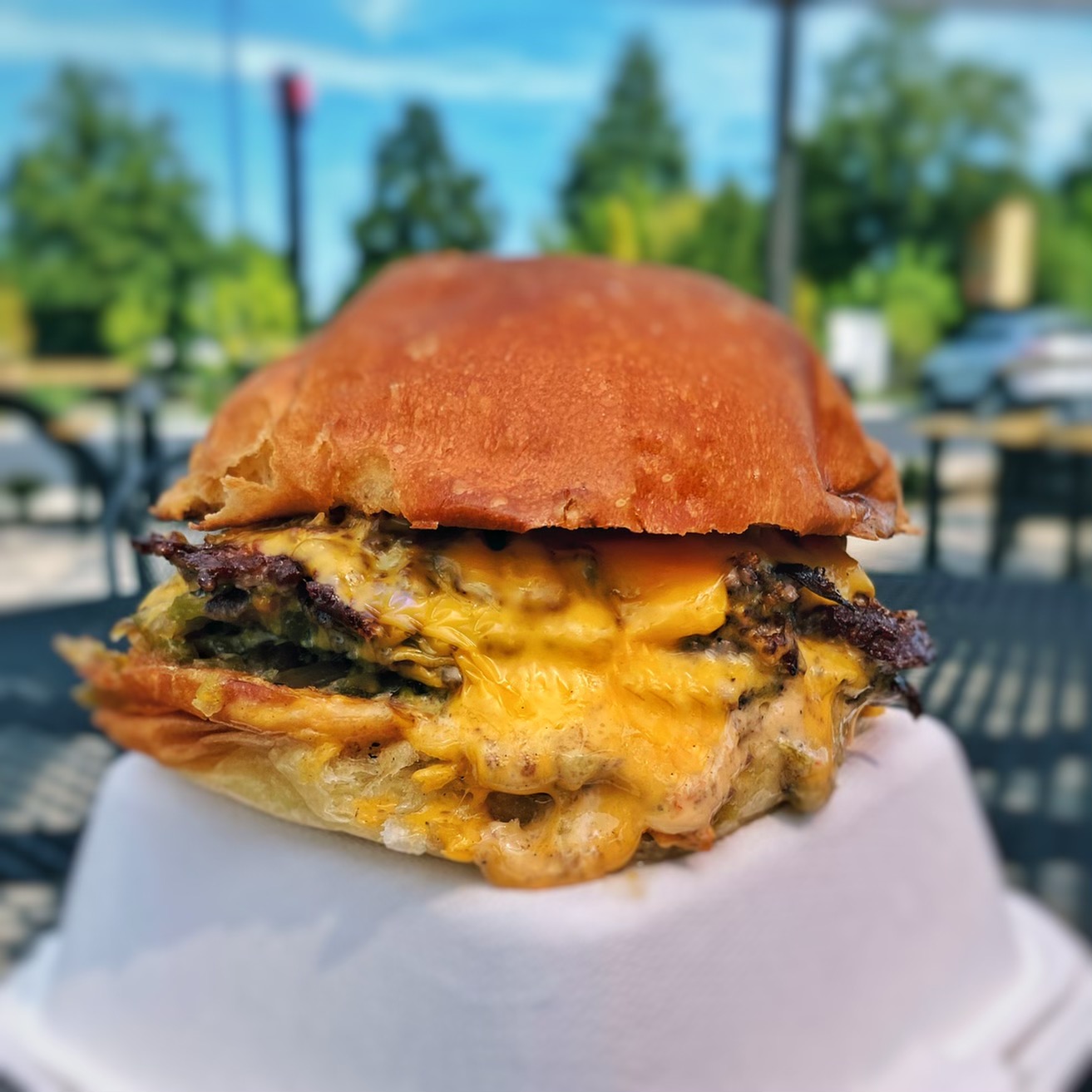 A cheeseburger sits on an upside-down box at Jojo.