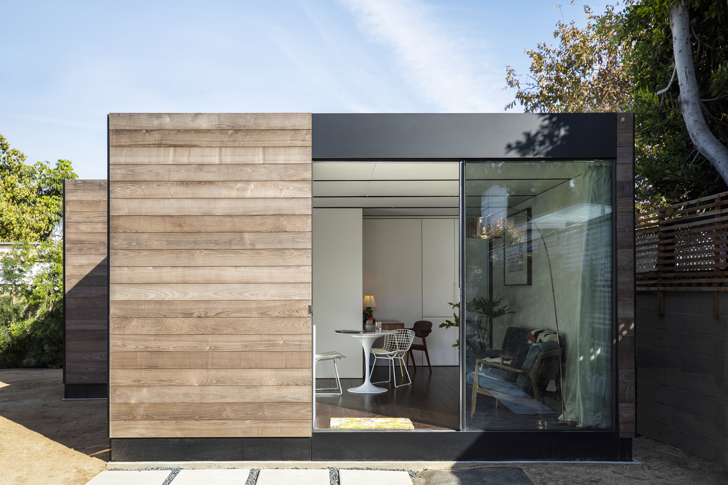 House clad in timber in backyard.