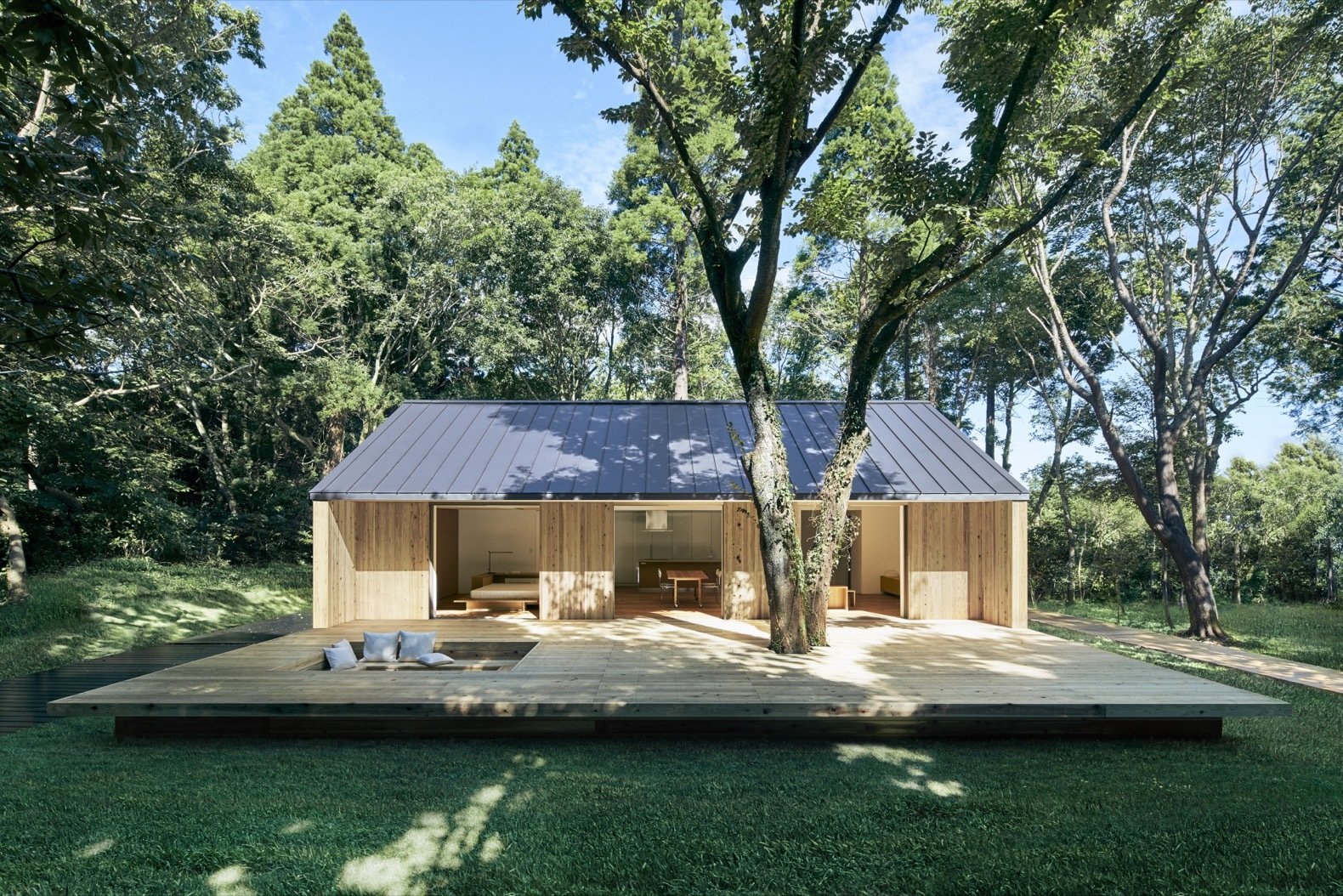 Single-story timber prefab home on grassy lawn.