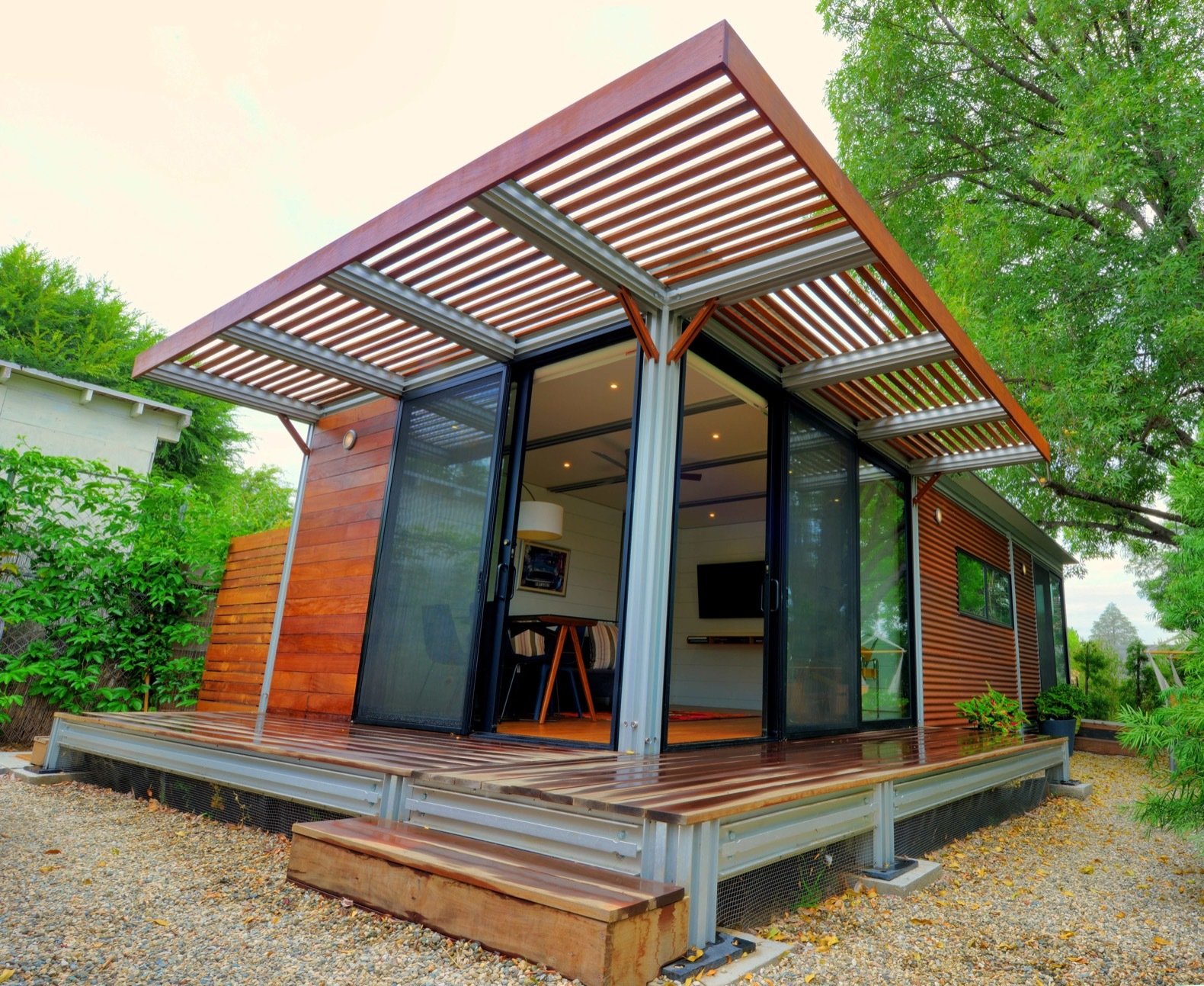 Boxy home with partially covered porch and sliding glass doors. 