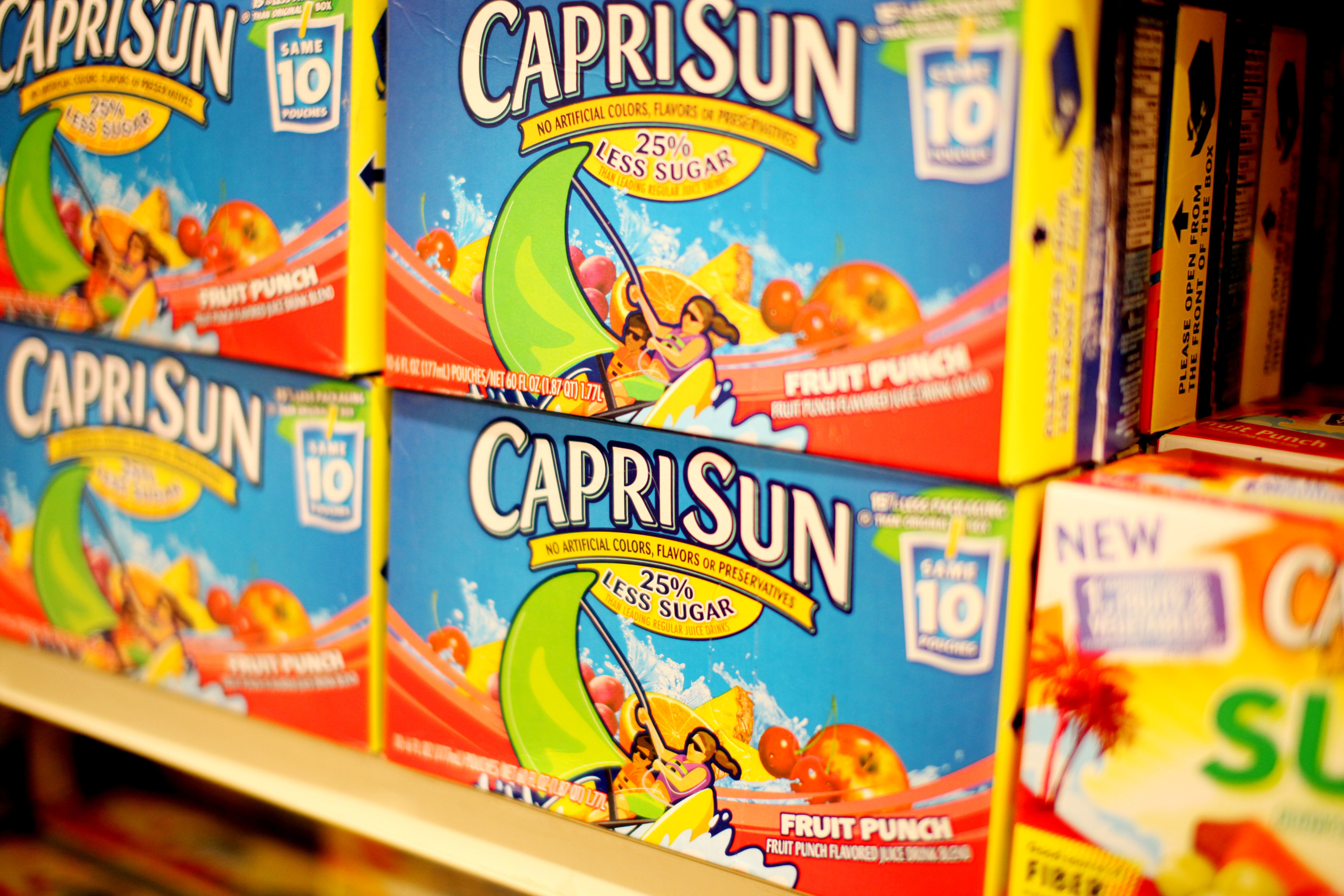 Boxes of Capri Sun on a grocery store shelf.