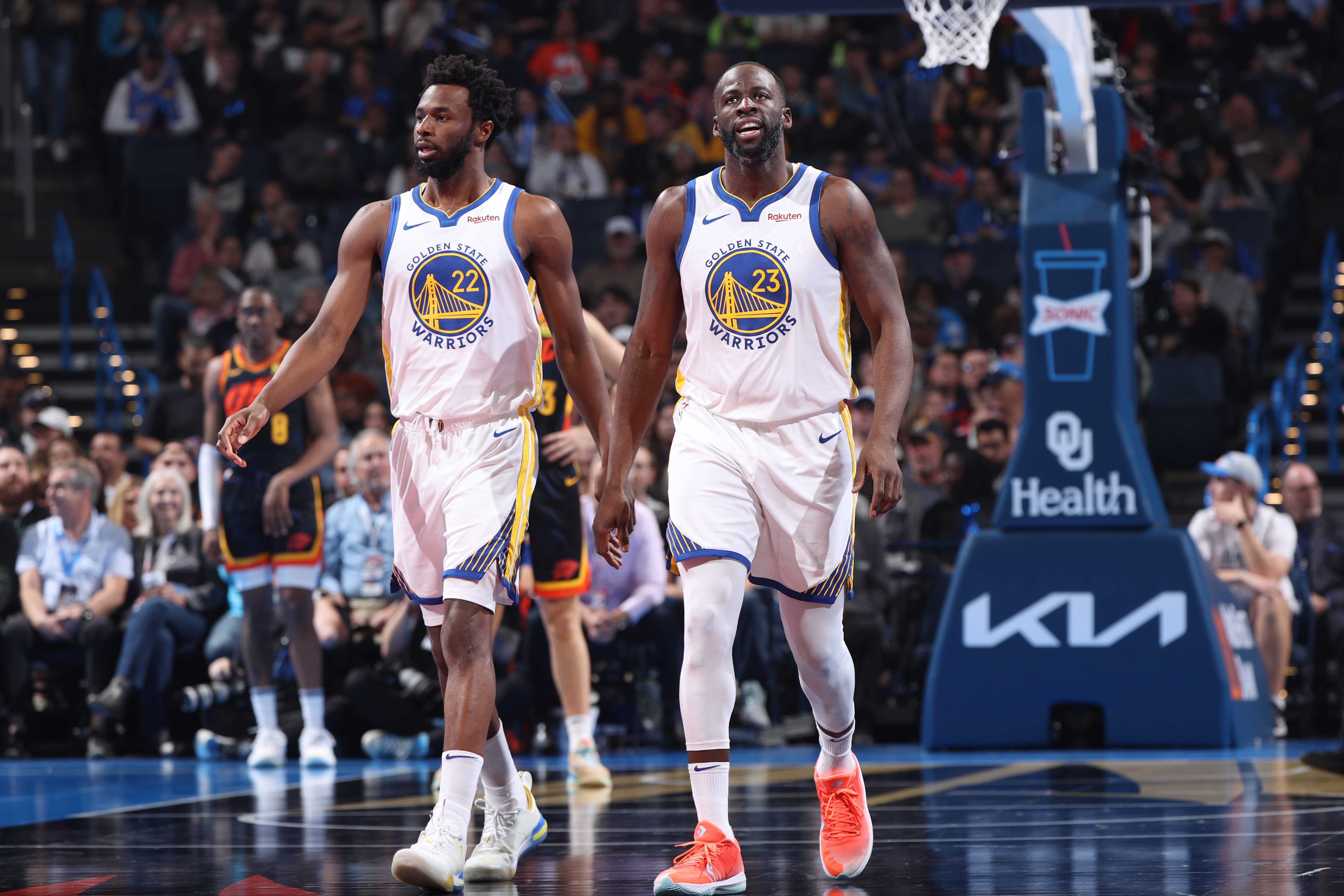 Draymond Green and Andrew Wiggins walking down the court next to each other. 