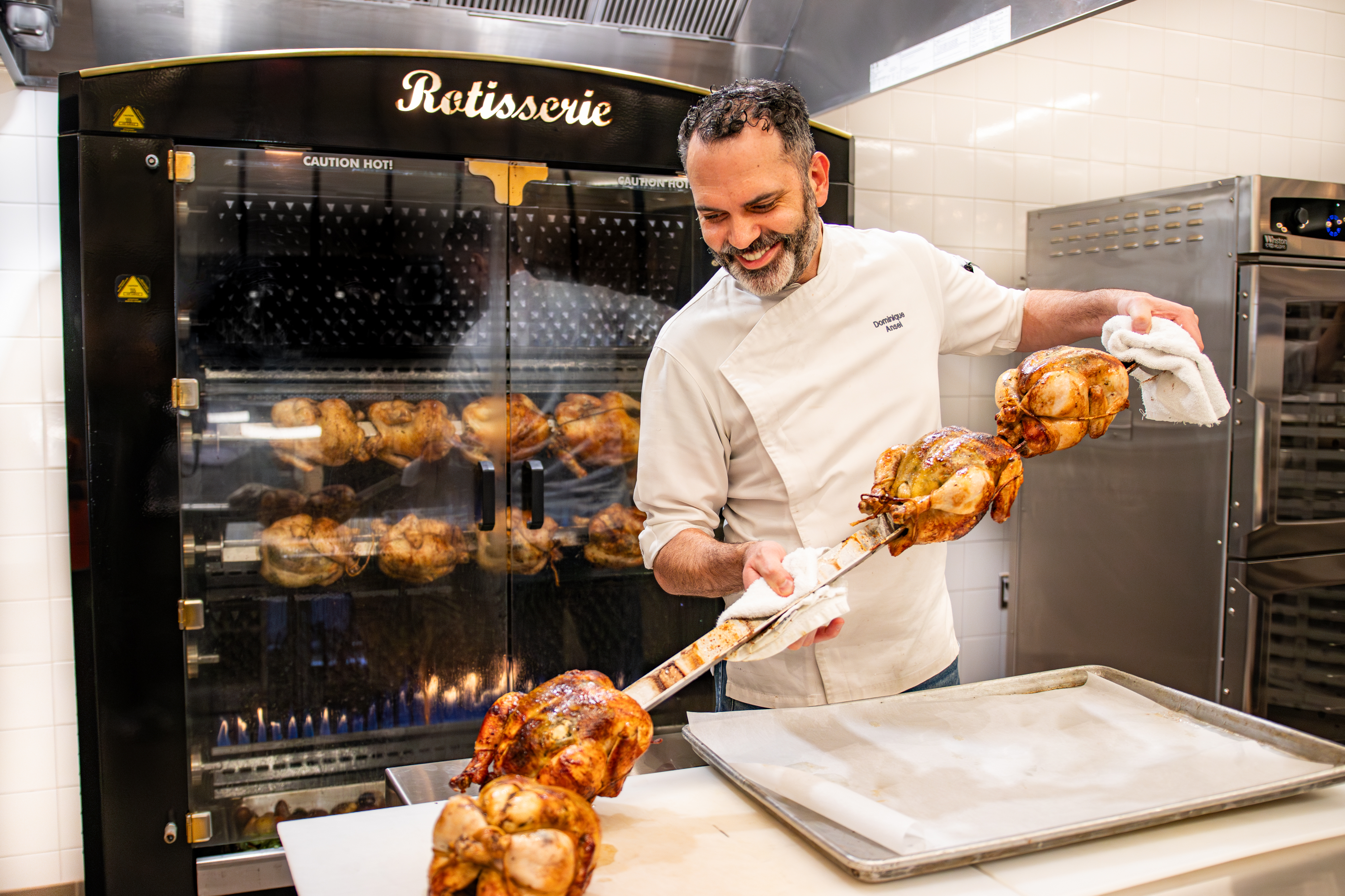 Dominique Ansel serves rotisserie chickens.