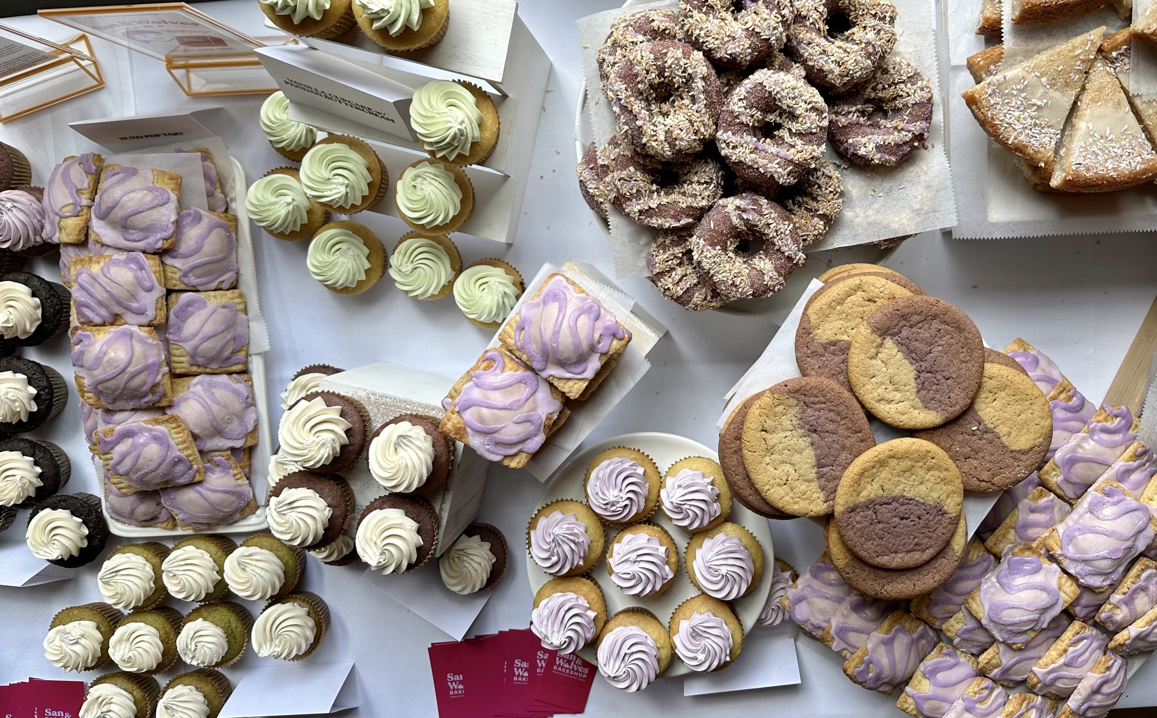 Overhead shot of a table of sweets from San &amp; Wolves including cookies, cupcakes, and more