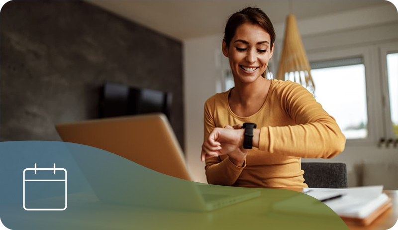 A woman looks at her watch while waiting for a live ableU session to start.