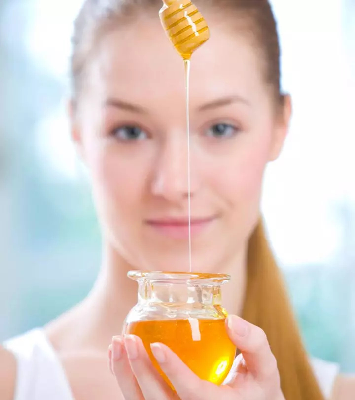 A woman showing honey for dry skin