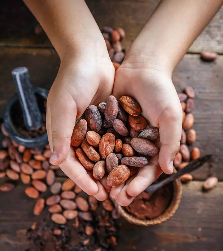 Dark chocolate pieces with some chocolate powder and coffee beans