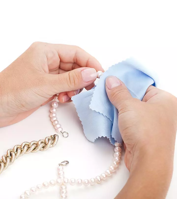 Person Cleaning Fake Jewelry