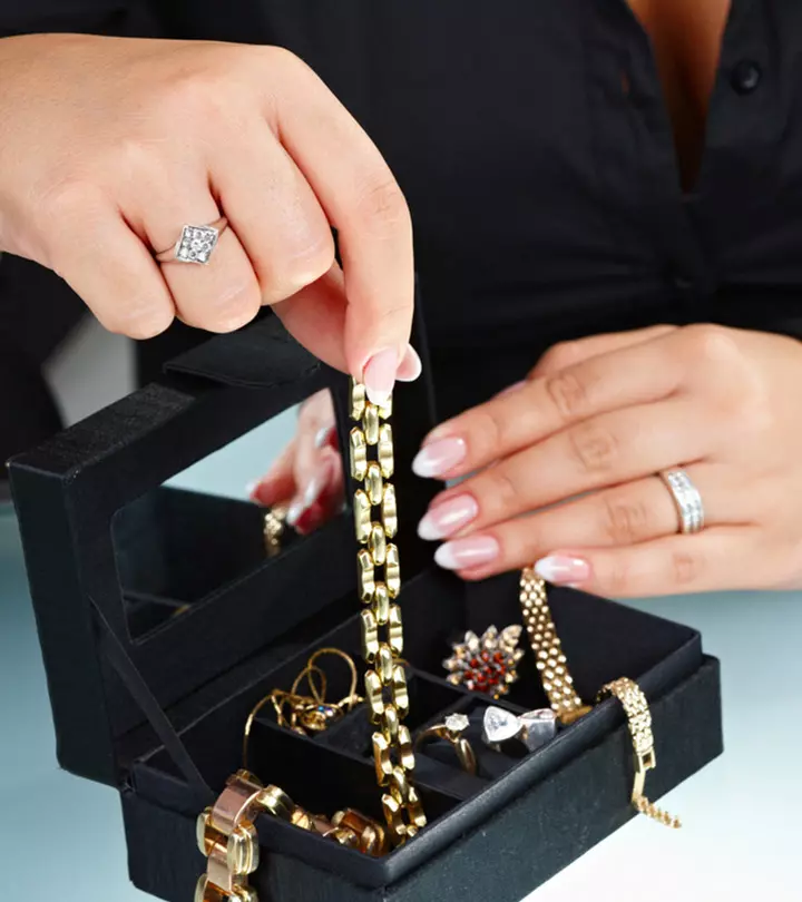 Person Cleaning Fake Jewelry