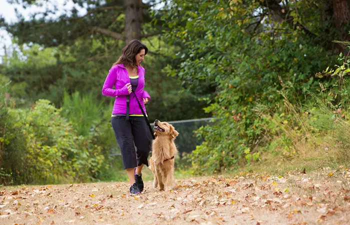 Woman walking her dog in a park