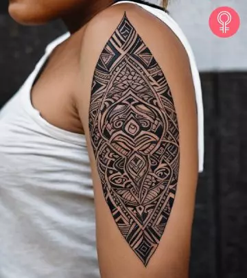 Nordic boat tattoo on a woman’s upper arm