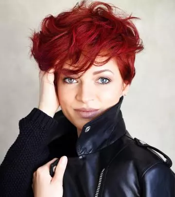 A woman with a red-colored fluffy pixie haircut