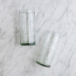 This is a clear tableware by Connected Goods called connected goods hand-etched floral recycled glassware in standard