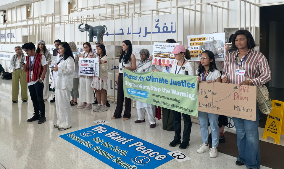 Campaigners protect about militarism and the climate crisis at COP28.