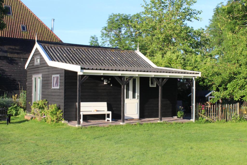 a small house with a bench under a roof at Bed and Stay Amsterdam in Amsterdam