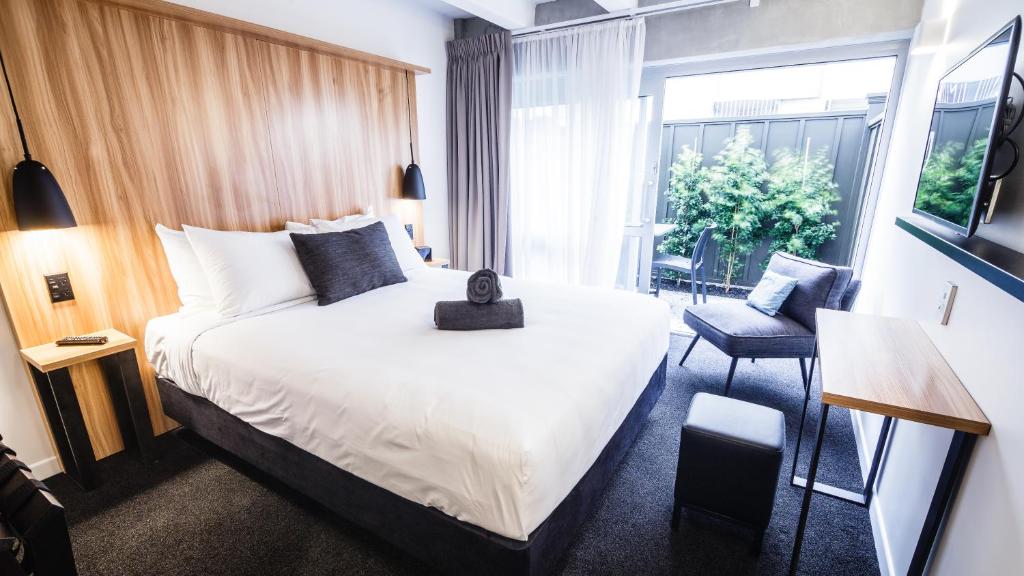 a hotel room with a large bed and a window at No. 9 Hotel in Auckland