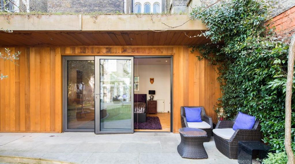 a patio with two chairs and a table at Romantic Bungalow in Notting Hill in London