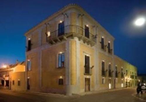 a building with a balcony on top of it at night at Palazzo Marzano in Briatico