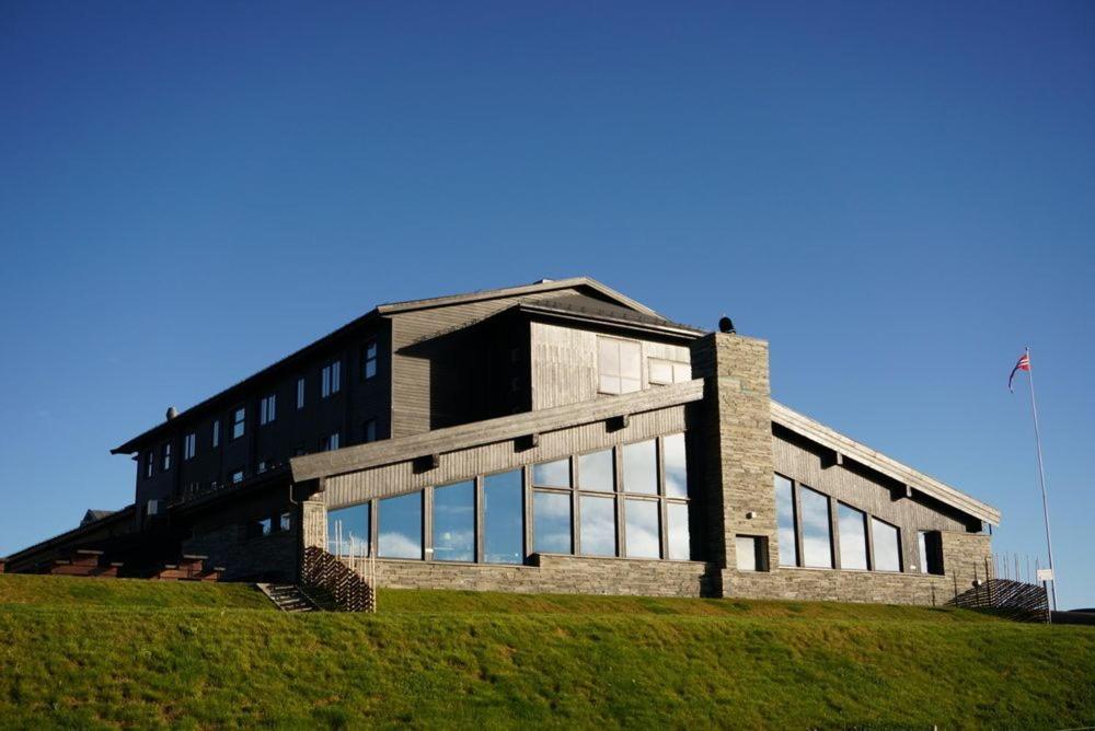 a building on top of a grassy hill at Pellestova Hotell Hafjell in Hafjell