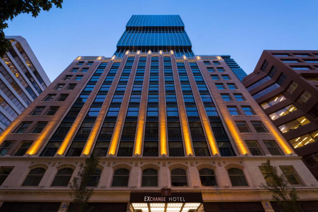 a tall building with lights on the side of it at EXchange Hotel Vancouver in Vancouver