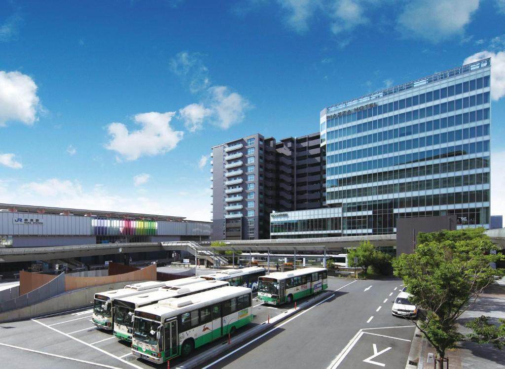 ein Parkplatz mit Bussen vor einem Gebäude in der Unterkunft Piazza Hotel Nara in Nara