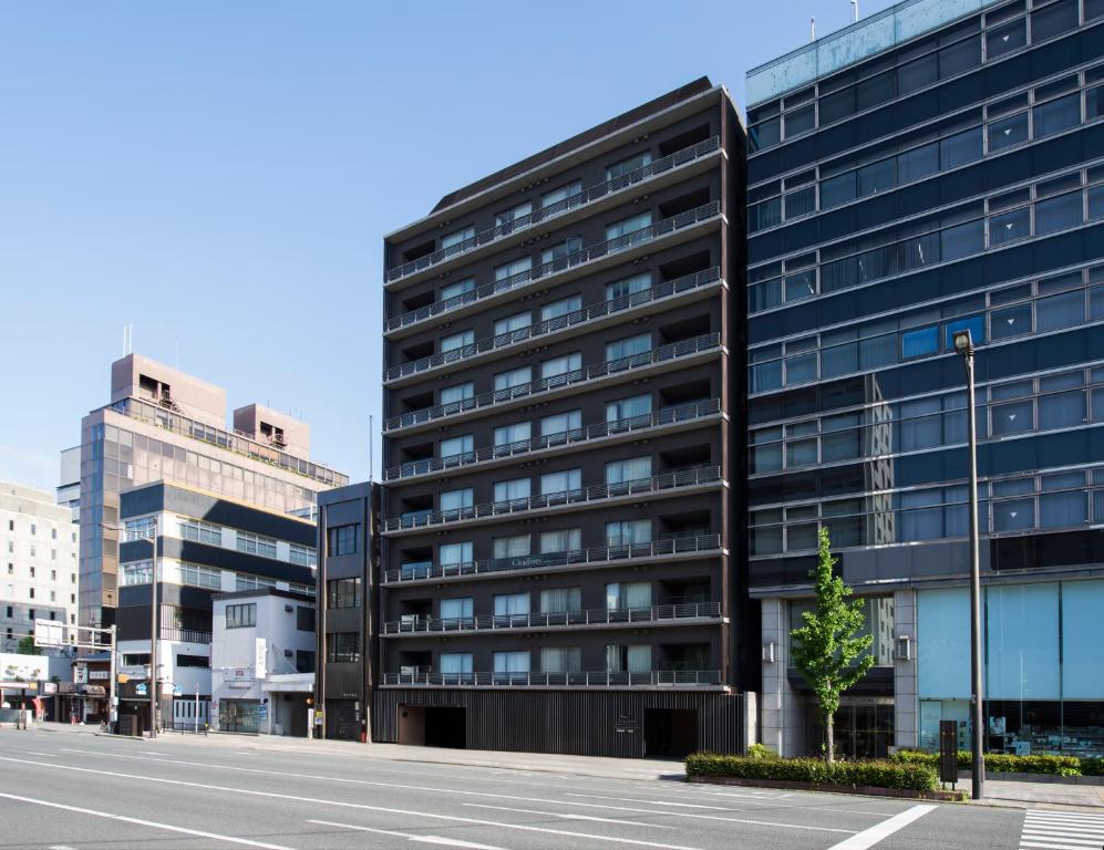 an empty street in front of a tall building at Citadines Kyoto Karasuma-Gojo in Kyoto