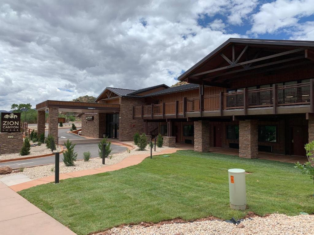 a large brick building with a lawn in front of it at Zion Canyon Lodge in Springdale