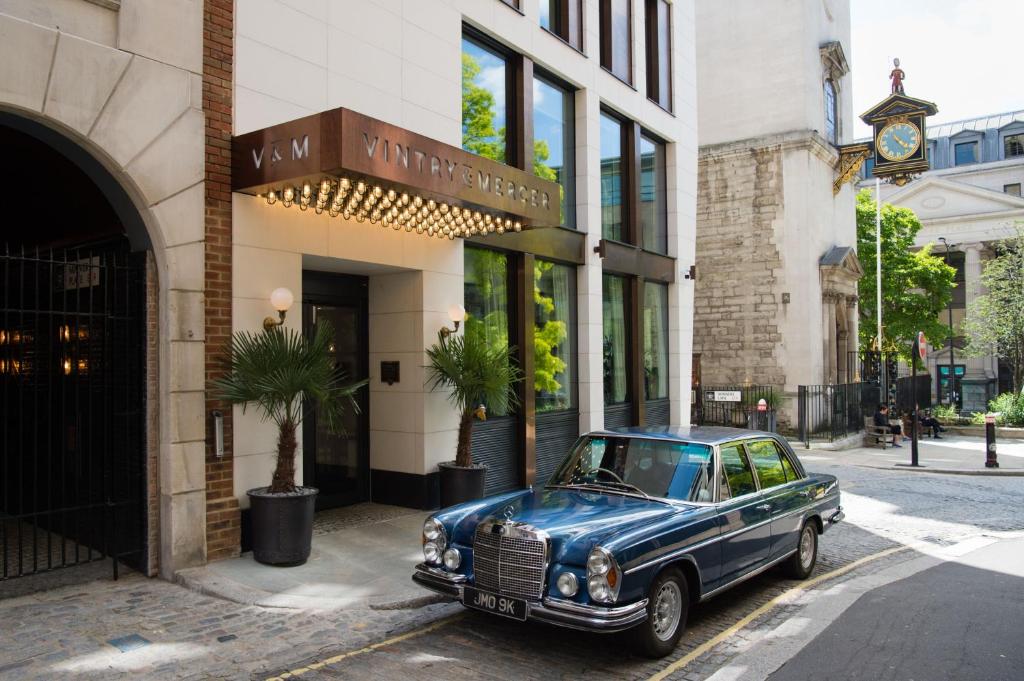 an old blue car parked in front of a building at Vintry & Mercer Hotel - Small Luxury Hotels of the World in London