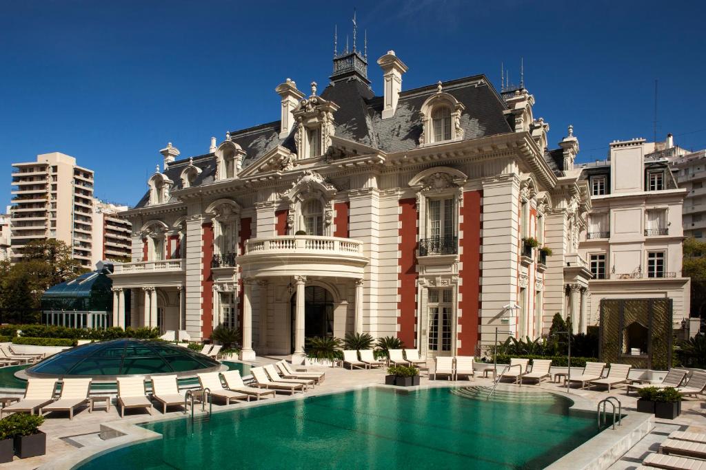 a large building with a swimming pool in front of it at Four Seasons Hotel Buenos Aires in Buenos Aires