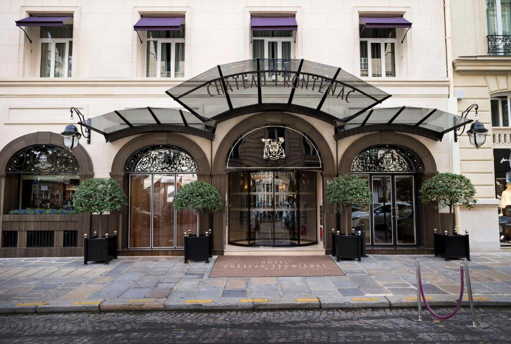 a facade of a building with a large doorway at Hôtel Château Frontenac in Paris