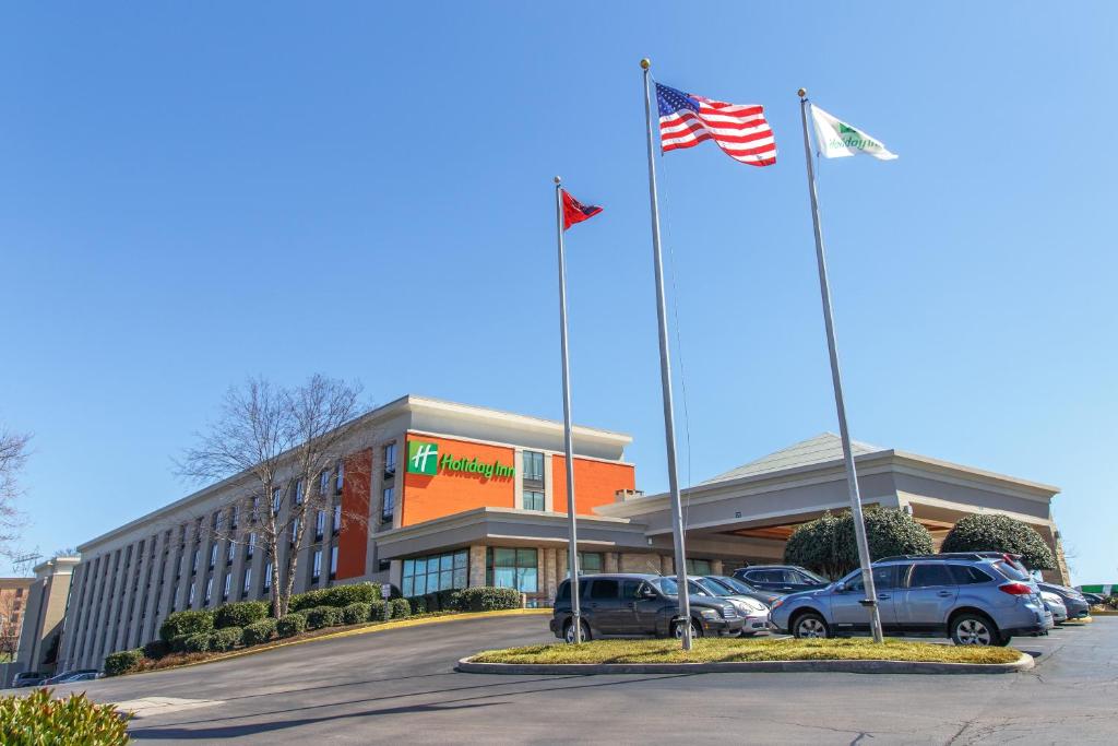 two american flags flying in front of a dealership at Holiday Inn Knoxville West - Cedar Bluff, an IHG Hotel in Knoxville