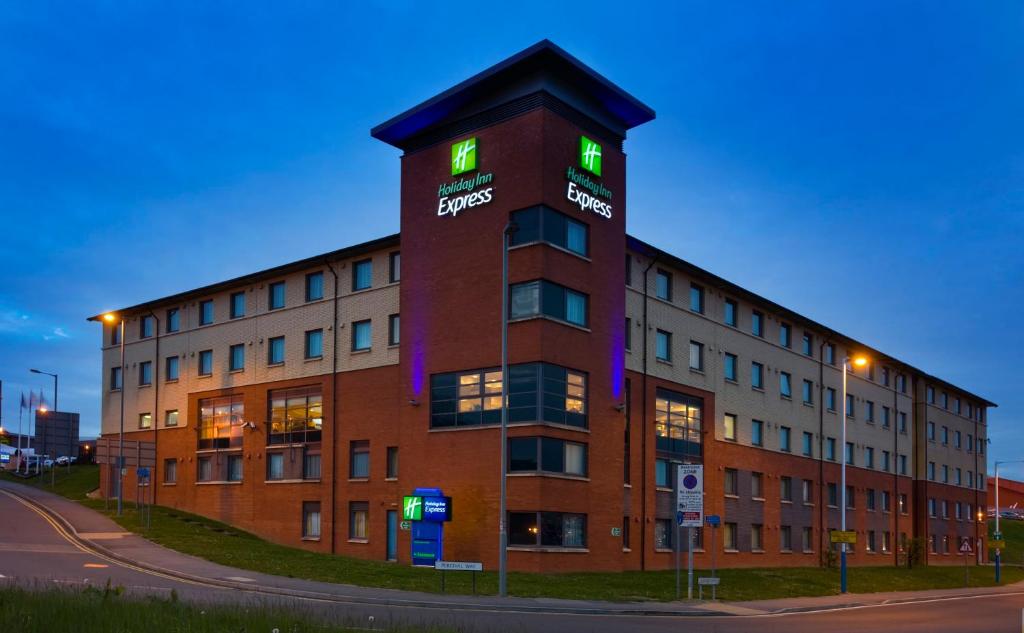 budynek z zielonymi światłami na górze w obiekcie Holiday Inn Express London Luton Airport, an IHG Hotel w Luton