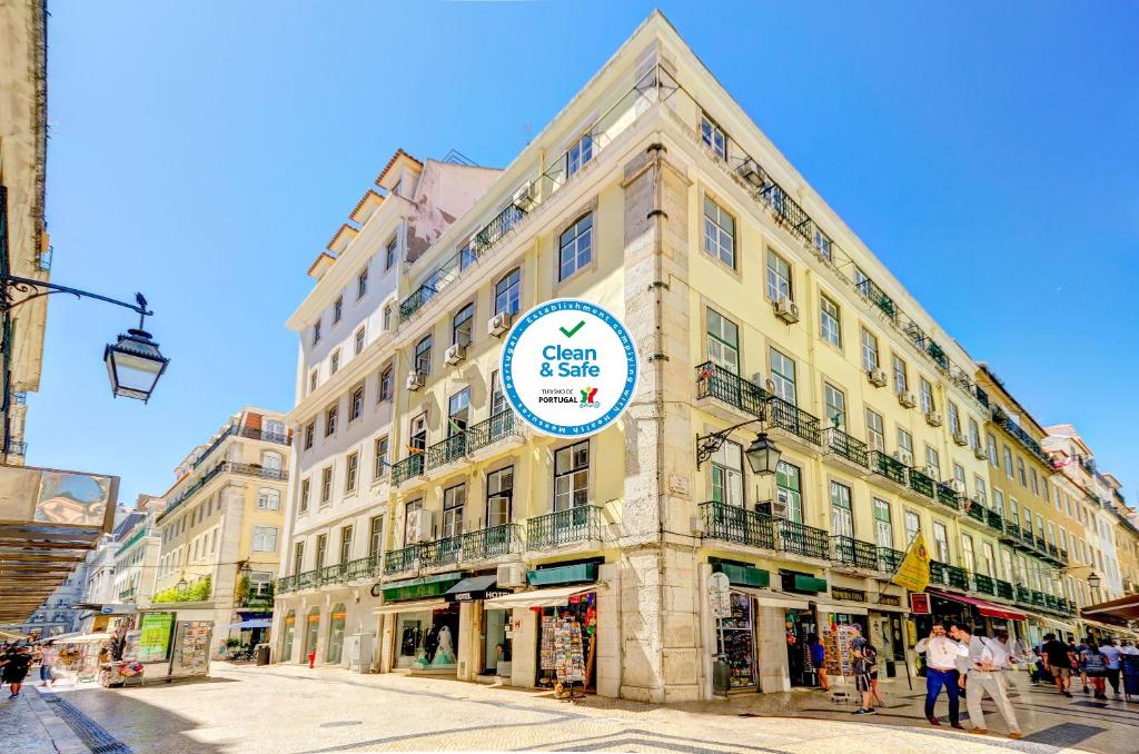 a large building with a sign on the side of it at Hotel LX Rossio in Lisbon