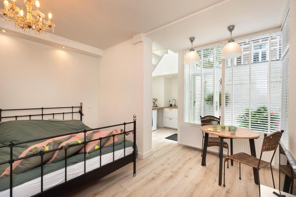 a bedroom with a bed and a table in a room at Boutique Studio Magielsen in Amsterdam