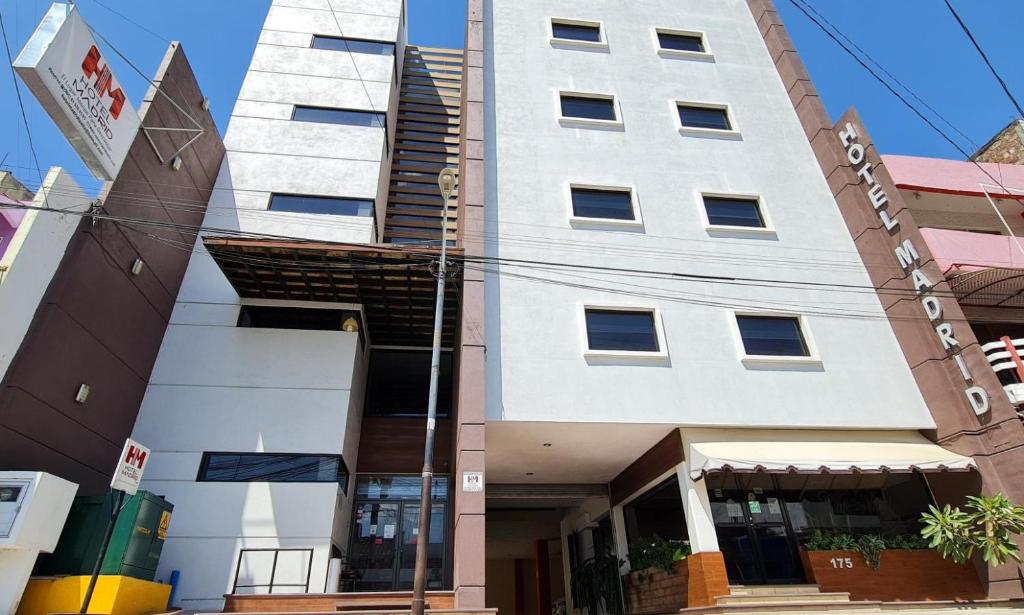 a tall white building in front of a building at Hotel Madrid in Tuxtla Gutiérrez