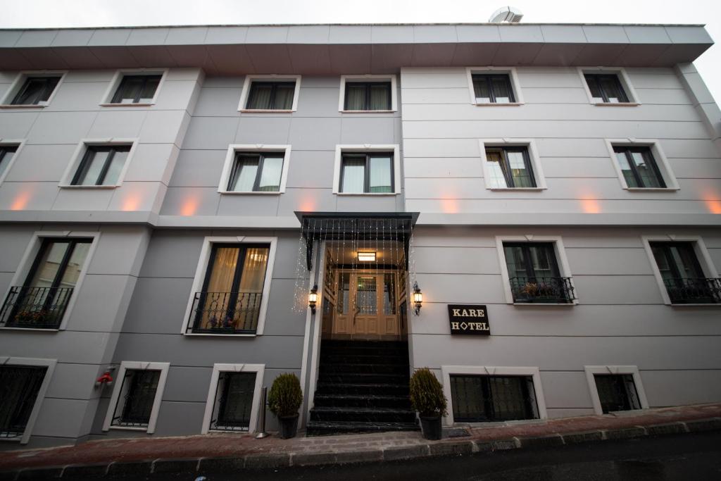 ein weißes Gebäude mit einer Tür und einer Treppe in der Unterkunft Kare Hotel Sultanahmet in Istanbul