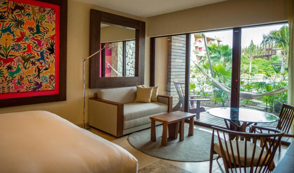 1 dormitorio con cama, sofá y mesa en Hotel Xcaret Arte - All Parks All Fun Inclusive - Adults Only, en Playa del Carmen