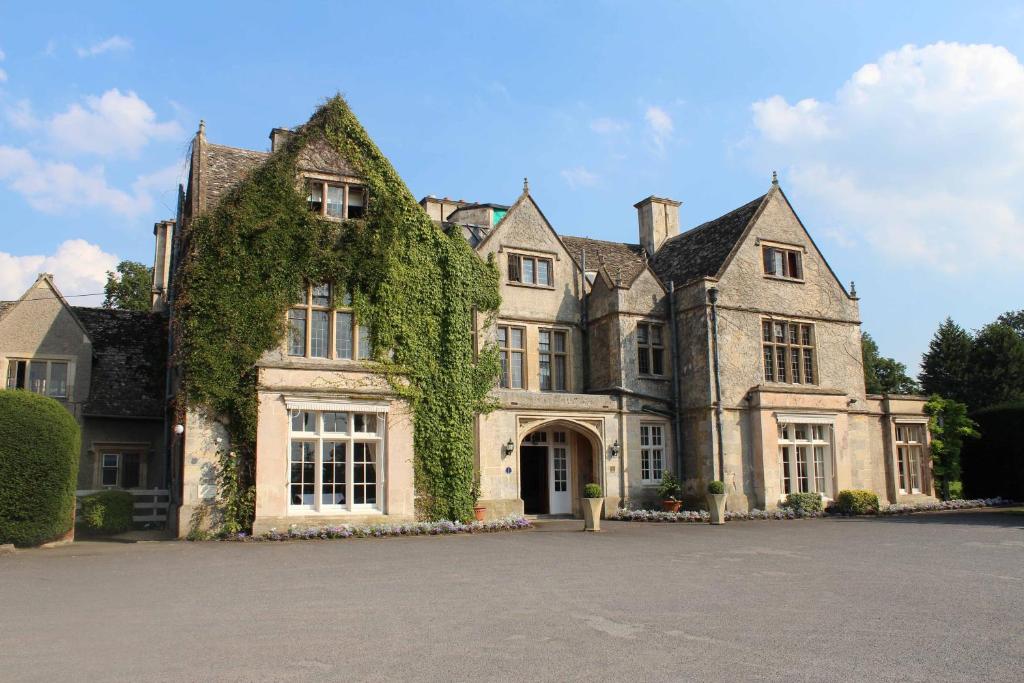 a large house with ivy growing on it at The Greenway Hotel & Spa in Cheltenham