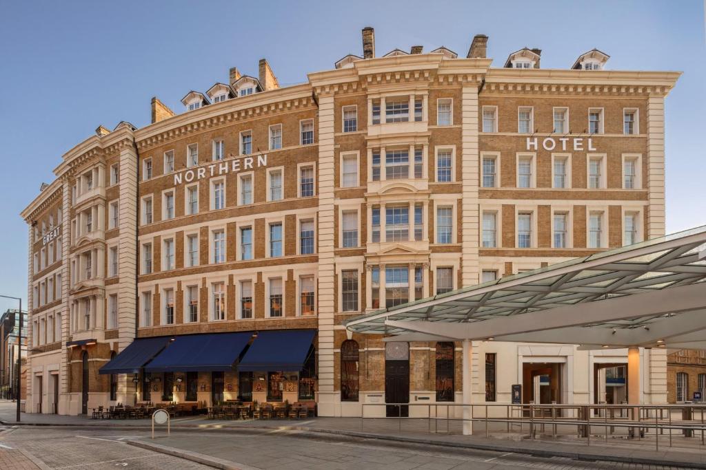 a large brick building with a hotel on a street at Great Northern Hotel, A Tribute Portfolio Hotel, London in London