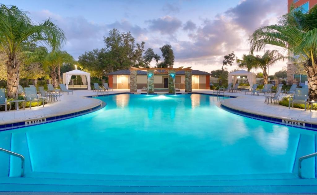 a large pool with blue water in a resort at Holiday Inn Express & Suites - Gainesville I-75, an IHG Hotel in Gainesville